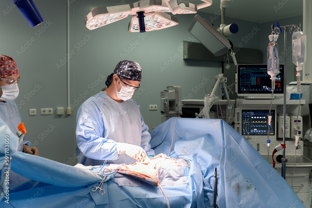 The faces of doctors surgeons in masks are a big plan, an operating