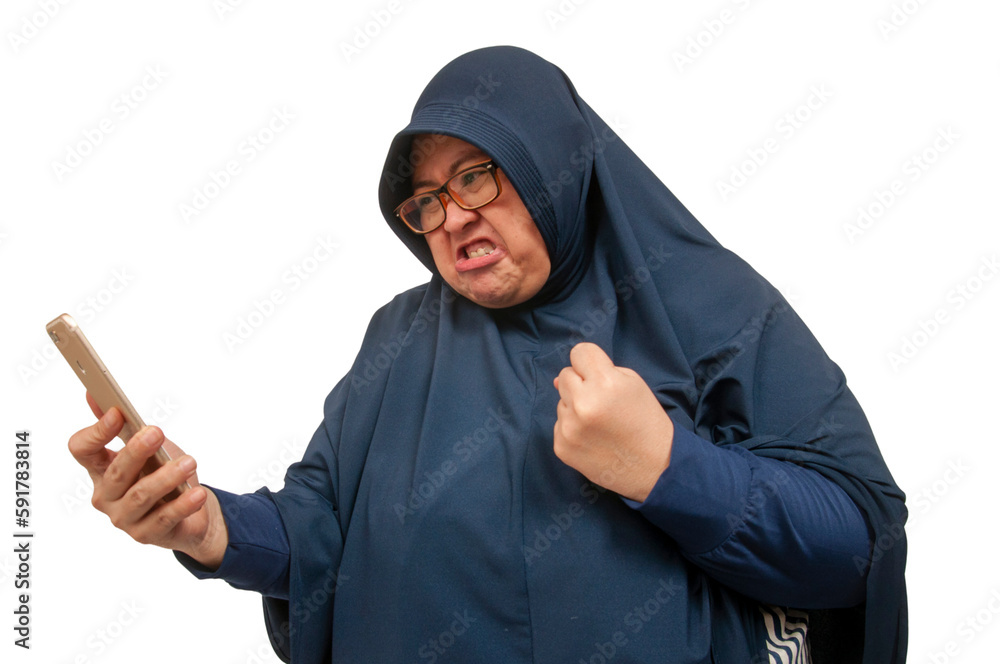 A big size Asian Muslim woman staring and texting with an upset and angry expression on her face. A big size Asian Muslim woman staring and texting with an upset and angry expression on her face.