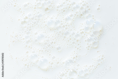 macro milk background White surface of milk and bubbles and ripples from above birds eye view
