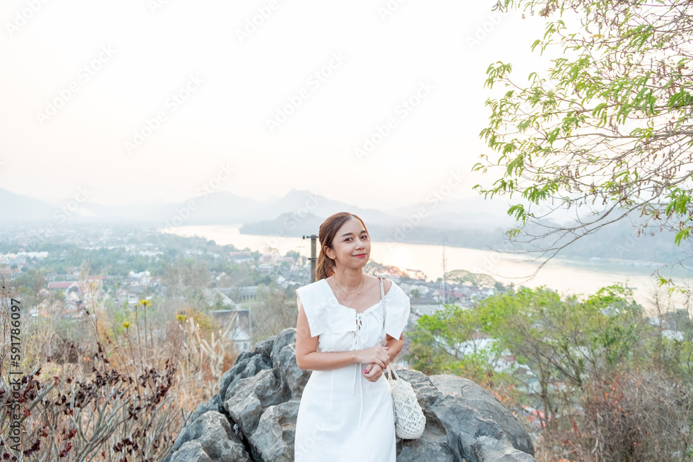 Portrait of Young Asian women at Mount Phou Si, is a 100 m high hill in the centre of the old town of Luang Prabang in Laos Portrait of Young Asian women at Mount Phou Si, is a 100 m high hill in the centre of the old town of Luang Prabang in Laos