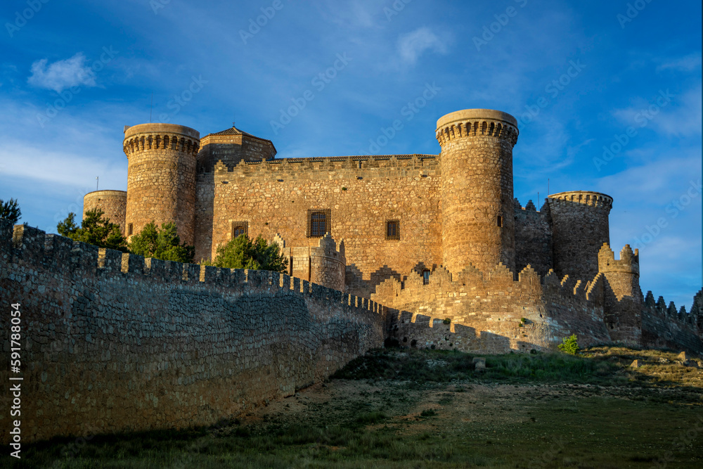 View of the impressive medieval fortress and castle of Belmonte in Cuenca, Spain with evening light