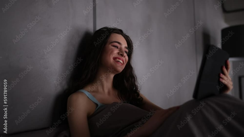 Young woman use tablet for video call while lying in her before sleepYoung woman make phone call while sit on sofa at home Young woman use tablet for video call while lying in her before sleepYoung woman make phone call while sit on sofa at home
