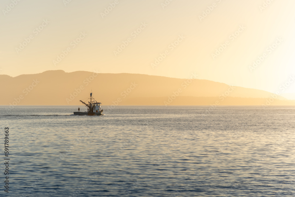 Fisherman on sailing boat in the evening