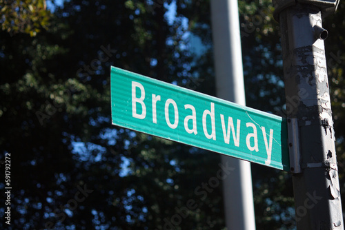 Broadway Street green traffic sign in New York between the skyscrapers