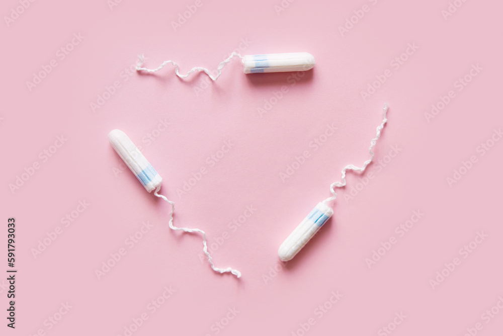 Feminine sanitary tampons on pink background. Hygiene care during critical days, caring for women's health. Monthly protection. Copy space. Menstrual cycle. Feminine sanitary tampons on pink background. Hygiene care during critical days, caring for women's health. Monthly protection. Copy space. Menstrual cycle.