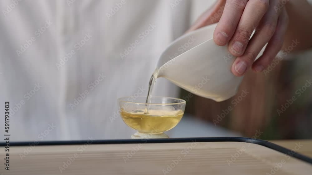 Mid adult man using smart phone and drinking tea in tea room,4K