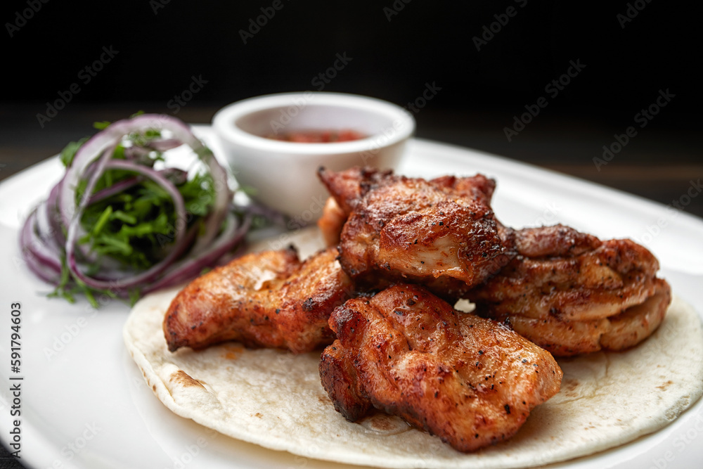 Mouth-watering chicken shish kebab with tangy tomato sauce