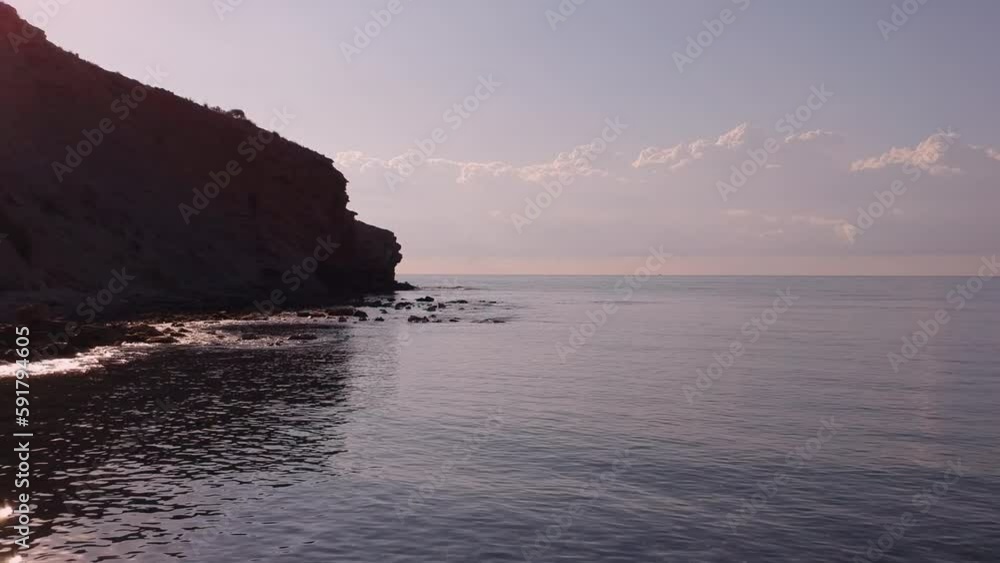 Pink sunrise on a paradisiac mediterranean beach, aerial video
