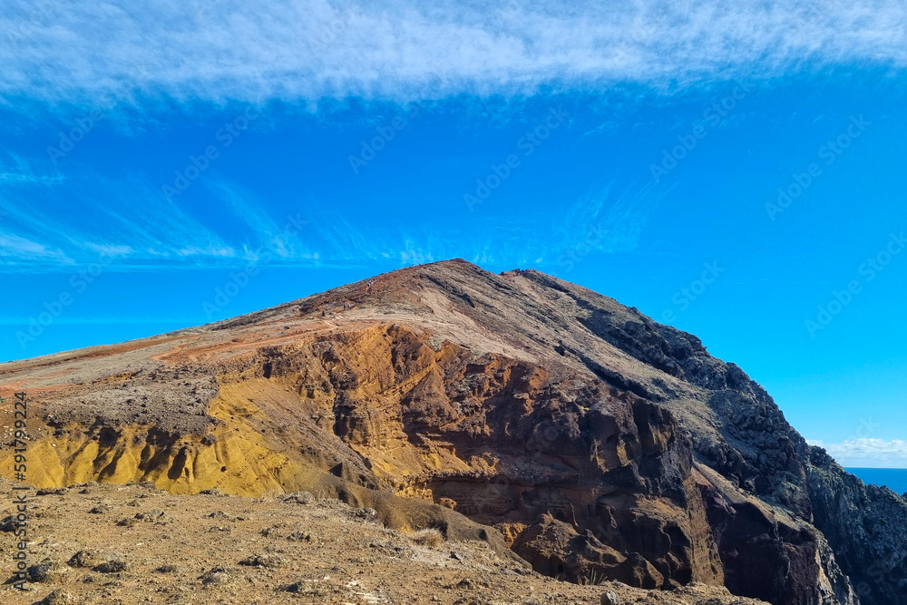 Beautiful texture of the mountain against the blue sky. Volcanic rocks.