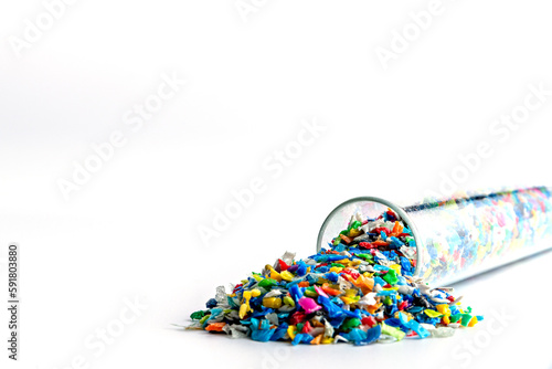 Small pieces of crushed plastic. Crushed bottle caps for recycling. Plastic waste that will be mixed with plastic vergin. Concept reducing plastic. photo