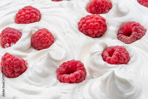 Fresh raspberries in the yoghurt or cream. Top view.