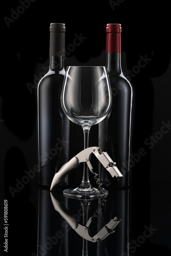 Two wine bottles next to each other, a wine glass and wine cutlery in front of a black background