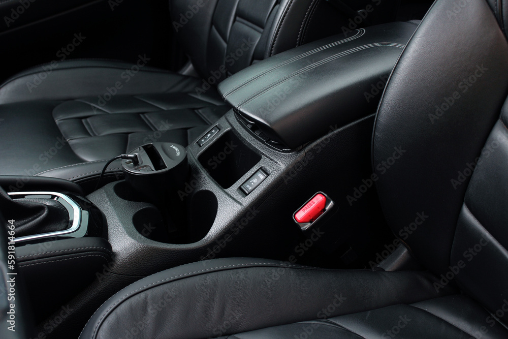 Interior of prestige modern car. Armrest modern lux car. Comfortable leather seats. The driver and front passenger seat of a luxury business class car. Luxury car inside. Black leather cockpit. Interior of prestige modern car. Armrest modern lux car. Comfortable leather seats. The driver and front passenger seat of a luxury business class car. Luxury car inside. Black leather cockpit.