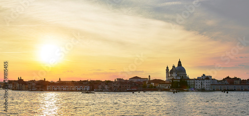 Beautiful bright sunset sky over the water and skyline of Venice, Italy
