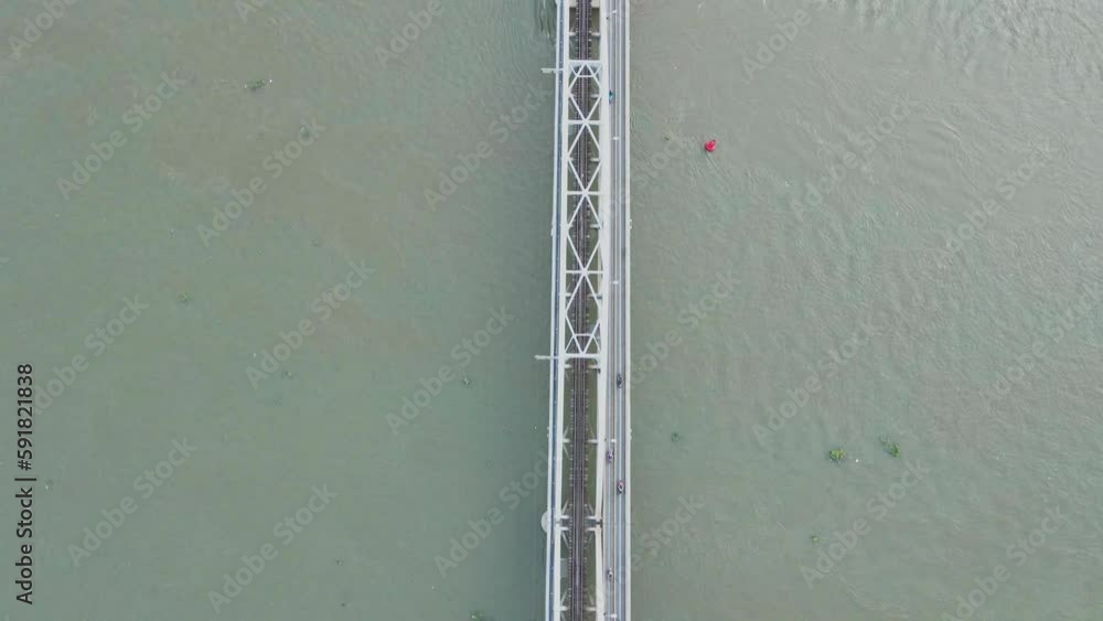 Drone shot of long bridge over tranquil river Drone shot of long bridge over tranquil river