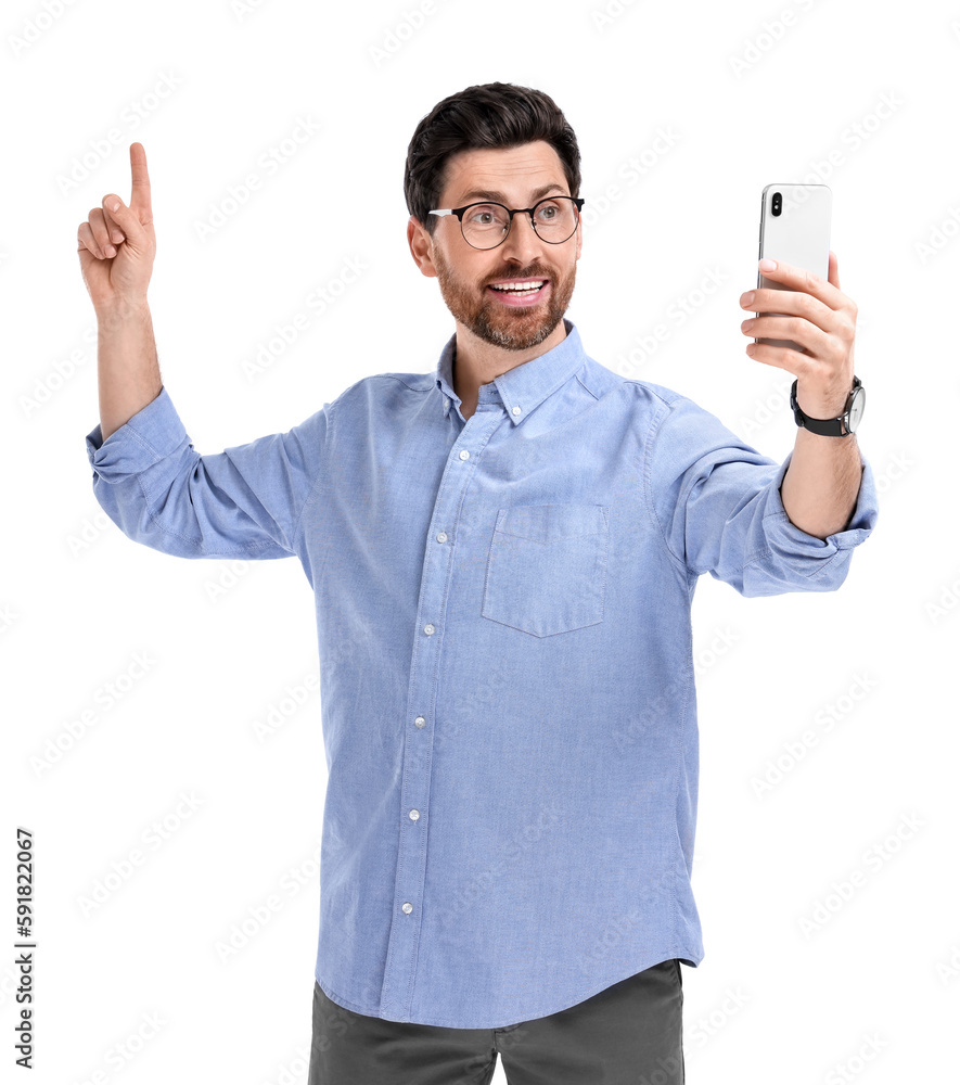 Smiling man taking selfie with smartphone on white background Smiling man taking selfie with smartphone on white background