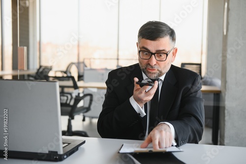 Frustrated businessperson angrily yelling at phone