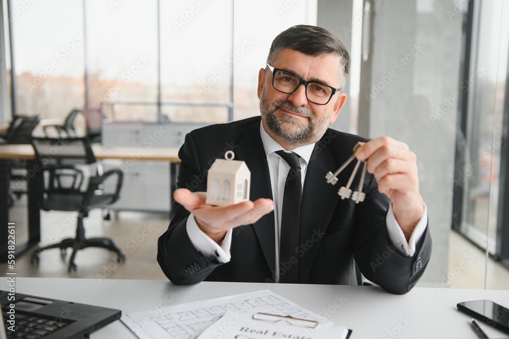 Real estate agent with house model and keys Real estate agent with house model and keys