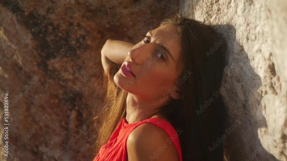 Closeup of a Caucasian woman standing near the sea Closeup of a Caucasian woman standing near the sea