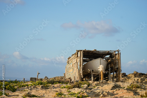 Panoramic view of a boat lying on the sand. Mediterranean scene in summertime holidays