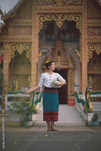 Songkran day with women in traditional Thai dress.