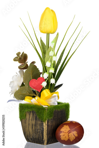 Easter egg. Yellow tulips in green can with light background.