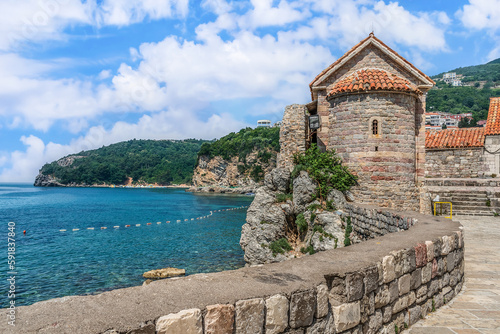 Ancient tower of the Santa Maria in Punta Church against the backdrop of the seascape of the Adriatic Sea in Budva, Montenegro. View from the observation deck of the Old Town to a delightful scenery