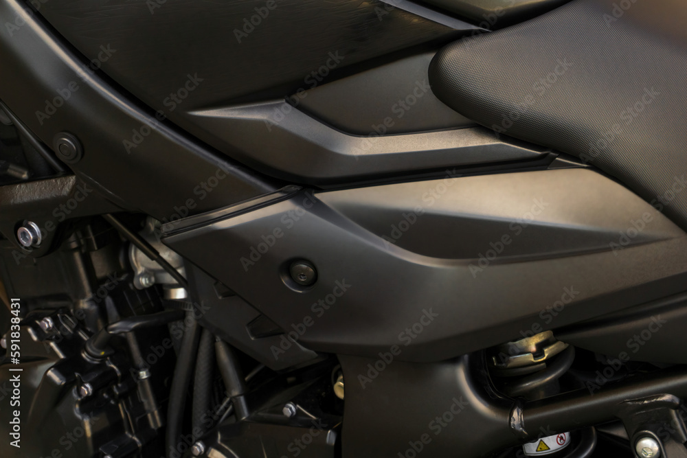 Detail of the tank of a black motorcycle close up