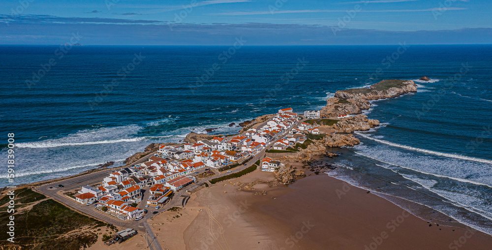 Fototapeta premium Aerial view of island Baleal near Peniche on shore of ocean west coast of Portugal with sandy beach