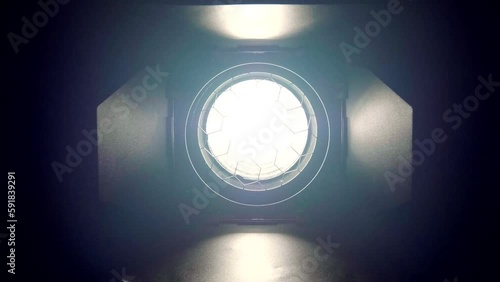 Video studio Fresnel lens spotlight on black background. Lights slowly turn on and off.