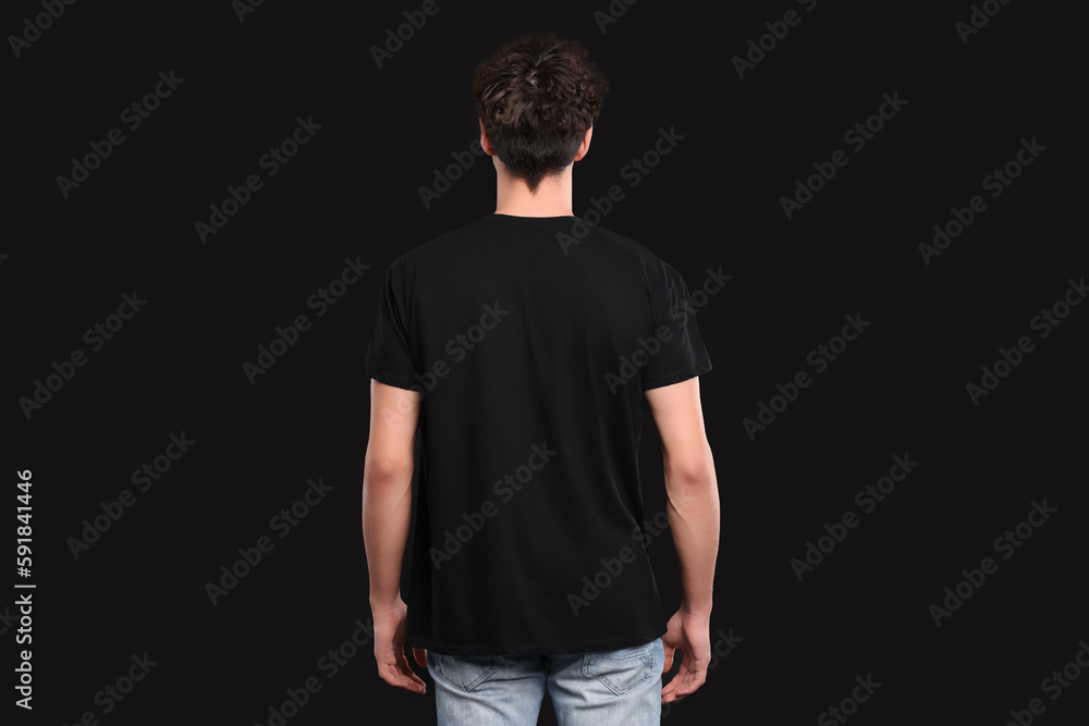 Man wearing stylish t-shirt on black background, back view. Mockup for design Man wearing stylish t-shirt on black background, back view. Mockup for design