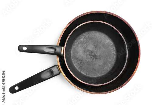 Dirty old frying pans on white background, top view