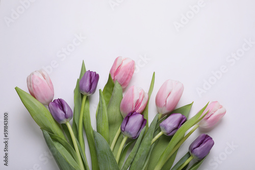 Beautiful tulips on light background, flat lay. Space for text