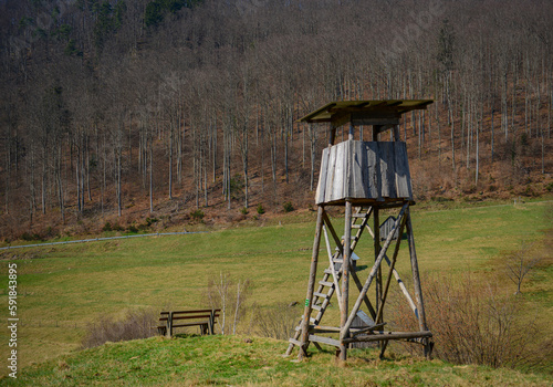 View of a wooden tree stand, or a deer stand, for hunters in the meadow