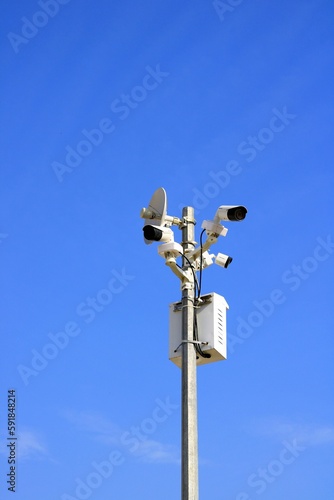 Street CCTV cameras are mounted on a pole, featuring multifunctional capabilities such as radars for monitoring city streets and roads photo