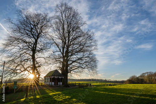 Small chapel under trees at sunrise, Bergisch Gladbach, Germany photo