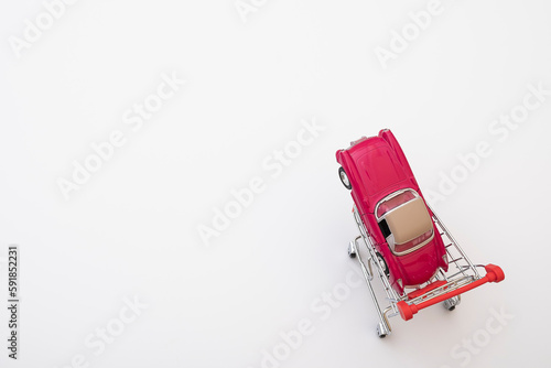 grocery cart and small car