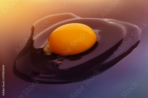 Broken raw egg on a dark background with a gradient.