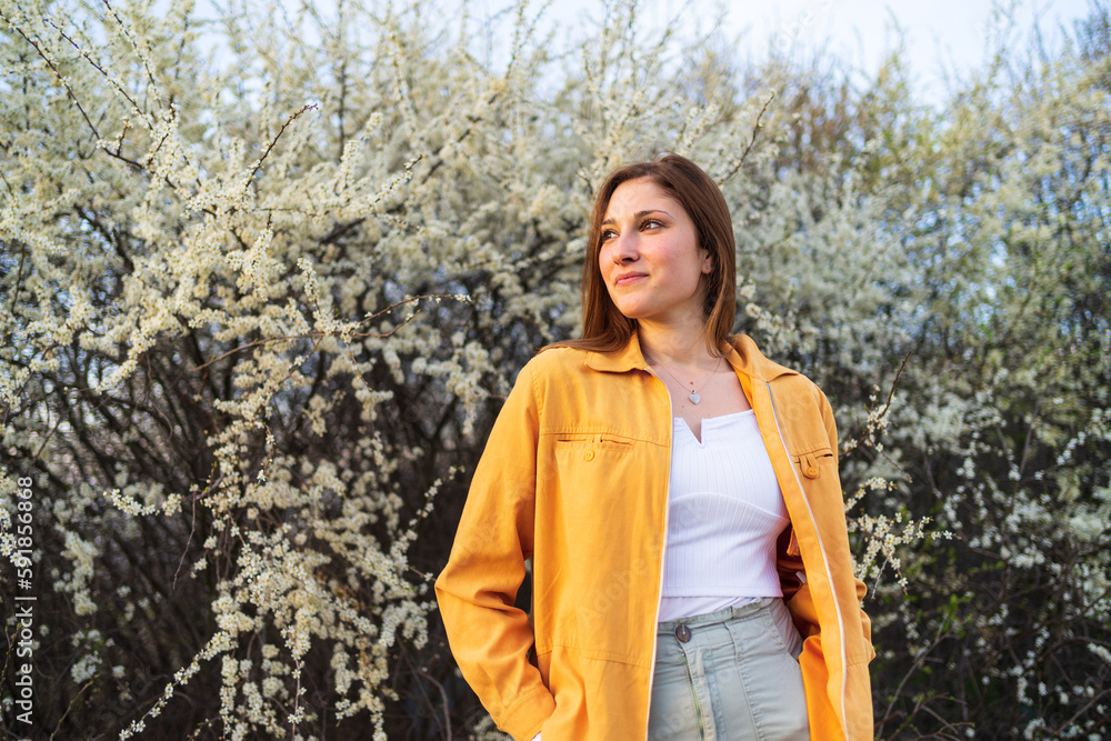 Portrait of young beautiful smiling woman standing by white blossom tree, spring time. Portrait of young beautiful smiling woman standing by white blossom tree, spring time.