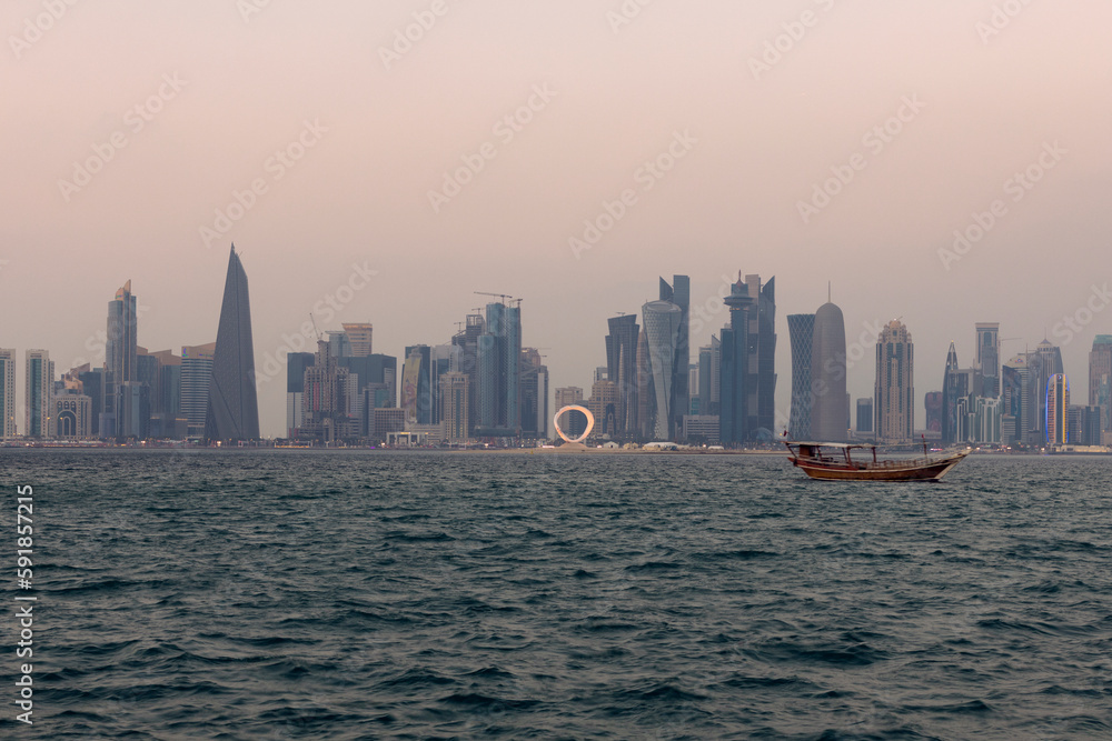 Doha, Qatar - December 12 2022: View of the Beach and sailing ships and towers in Doha Corniche in Qatar