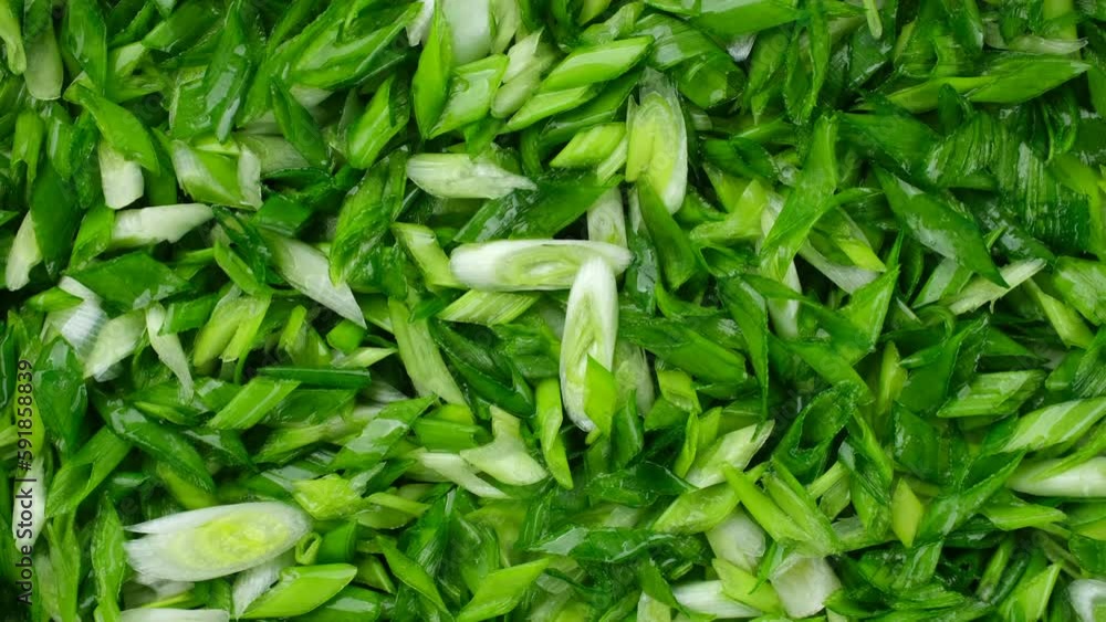 Chopped green onions top view, rotation. A heap of chopped green onions. Seasonal greens for salad Chopped green onions top view, rotation. A heap of chopped green onions. Seasonal greens for salad