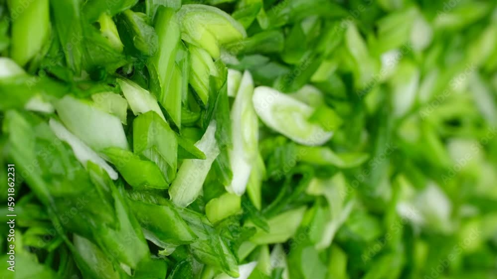 Chopped green onions. A heap of chopped green onions. Seasonal greens for salad. Vertical footage