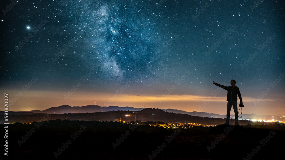 Closeup shot of a Caucasian man looking at the landscape in Germany at night