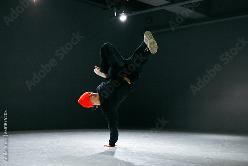 bboy freezes in one pose in stylish studio a man Hiphop dancer  photo