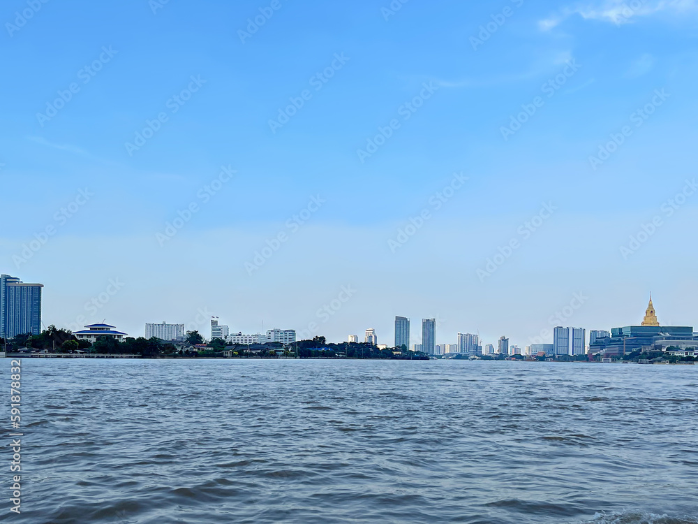 Сity view, Bangkok, Thailand. Beautiful panoramic view from the Chao Phraya River to the Government House and other buildings on the embankment along the water line. Expanse of water.