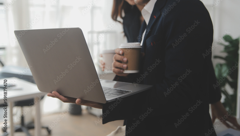 Business professionals. Group of young confident business people analyzing data using computer while spending time in the office