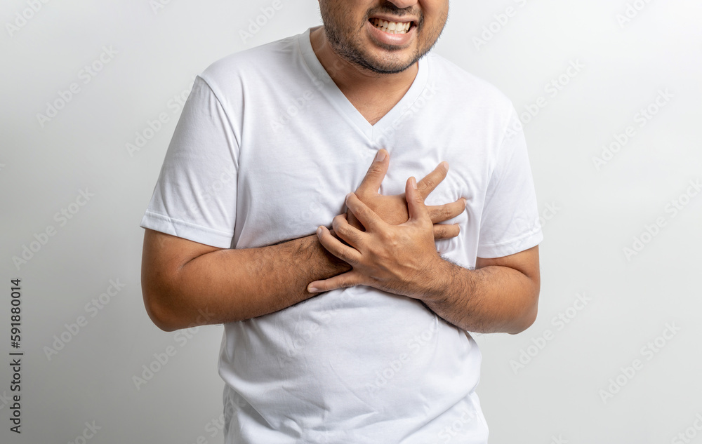 Young Asian man he felt a pain in his chest held his hand and squeezed