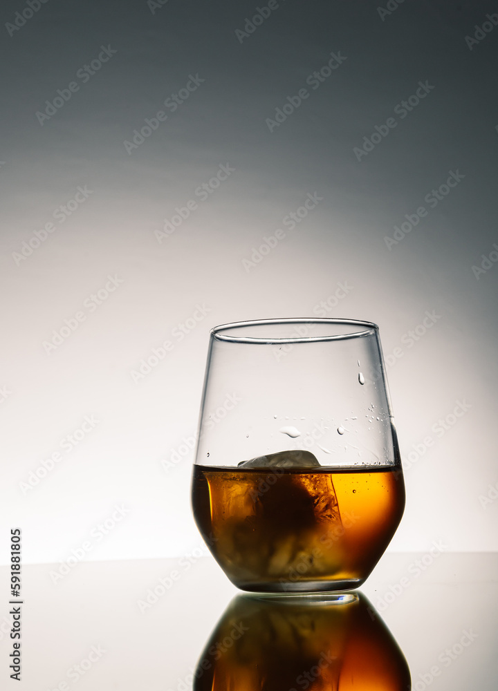 Iced Alcohol drink in a glass cup with reflection on a mirror surface Iced Alcohol drink in a glass cup with reflection on a mirror surface