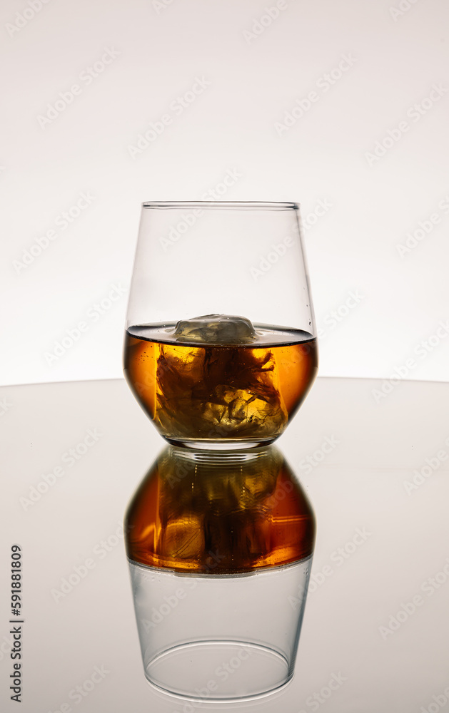 Iced Alcohol drink in a glass cup with reflection on a mirror surface Iced Alcohol drink in a glass cup with reflection on a mirror surface