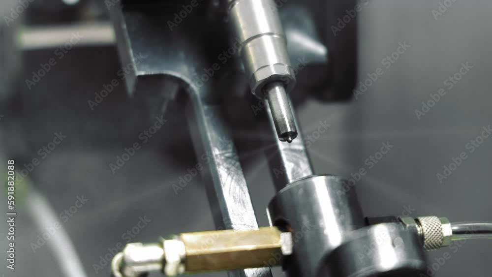 Operation of the injector on the diagnostics stand. A diesel injector sprays fuel Operation of the injector on the diagnostics stand. A diesel injector sprays fuel